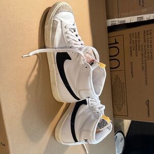 Nike White High-Top Sneakers with Black Swoosh and Yellow Heel Tab